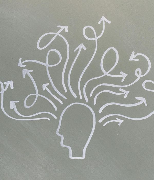 Person looking thoughtfully towards a bright window, symbolizing mental clarity.